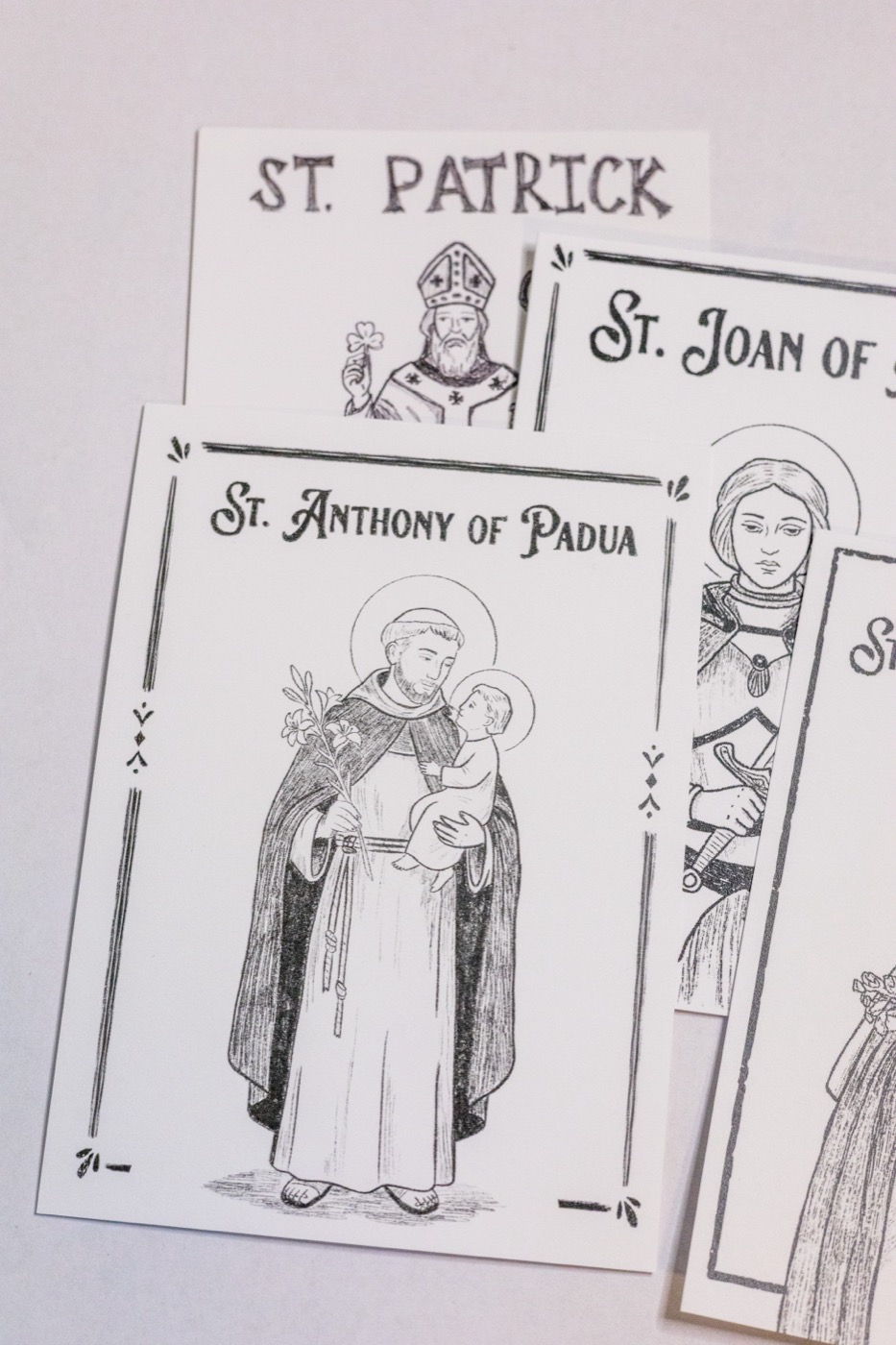 Hand-drawn pencil prayer cards for St. Patrick, St. Joan of Arc, and St. Anthony of Padua